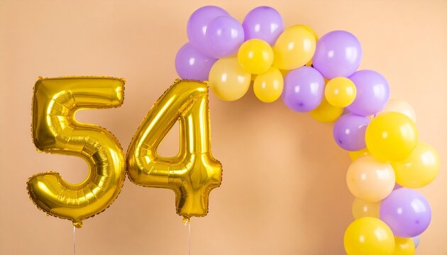 Golden 54 number balloons with a colorful purple and yellow balloon arch