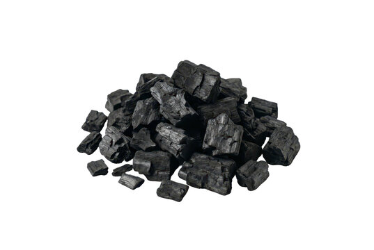 Heap of natural carbonized wood lumps isolated on black background