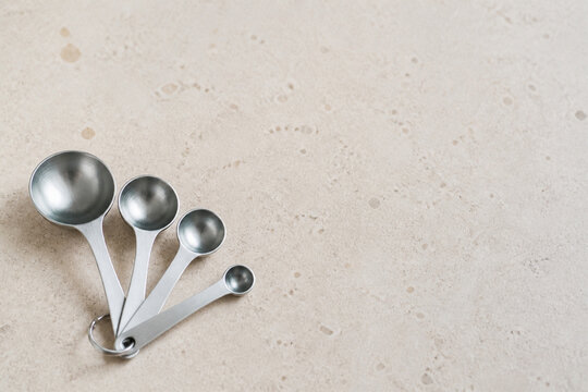 Plain Measuring Spoons Nested in a Shallow Fan