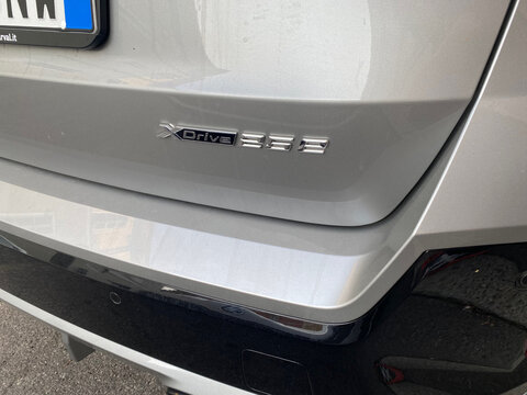 Close-up view of the rear emblem on a silver BMW X3 xDrive30e, highlighting its plug-in hybrid designation and all-wheel-drive system