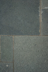 Fototapeta premium Dark stone tiles arranged in a grid pattern