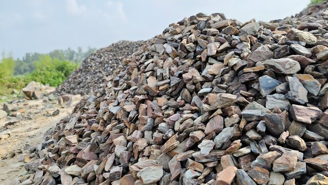 Large pile of crushed gravel and stones for construction and industrial road building.