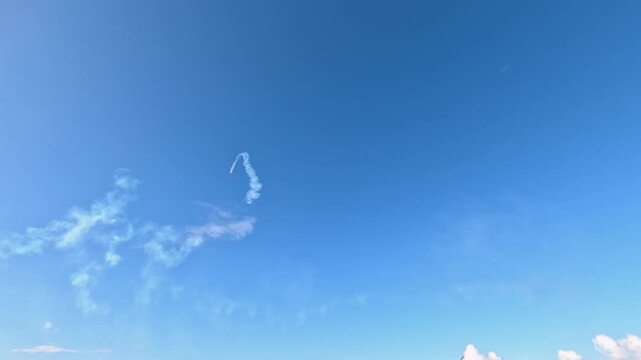Aerobatic Jet Performing Stunts with Smoke Trails in Gold Coast Sky