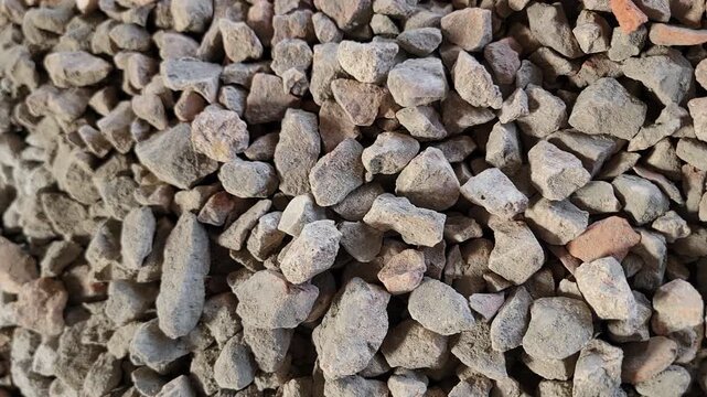A detailed close up view of small gray gravel stones filling the frame