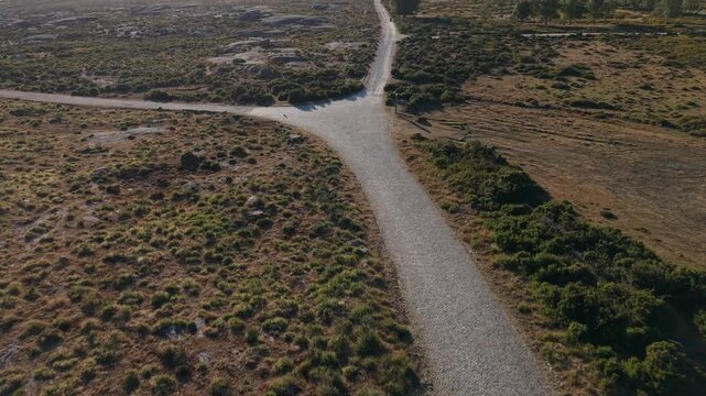Aerial gravel track crossing granite moorland on Nossa Senhora do Minho Alto Minho Portugal