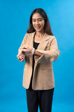 Professional Woman Checking Smartwatch with Happy Expression