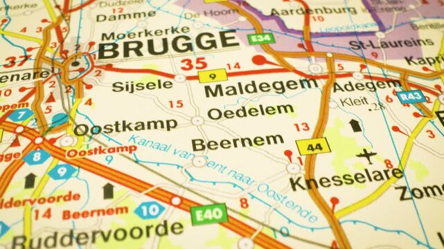 gliding shot over atlas map highlighting road routes to brugge,belgium