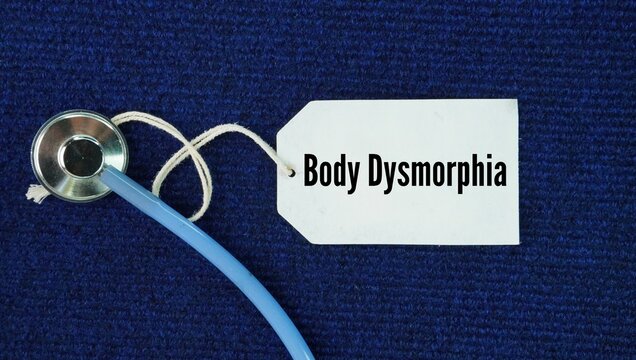 Stethoscope and paper tag with the word Body dysmorphia. mental health condition defined by an obsessive preoccupation with perceived flaws in one's physical appearance that are minor