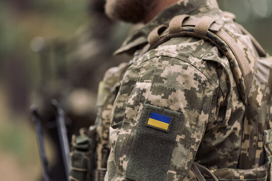 Ukrainian soldier wearing pixel camouflage with flag patch