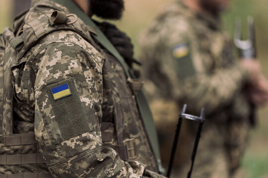 Ukrainian soldier in pixel camouflage with flag patch