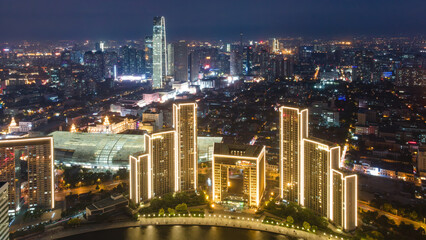 Naklejka premium Night View of Modern Urban High-rise Buildings by River