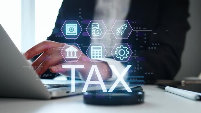 A person is using a laptop to handle tax-related tasks in a modern office. Several icons appear on the screen, showing financial concepts.