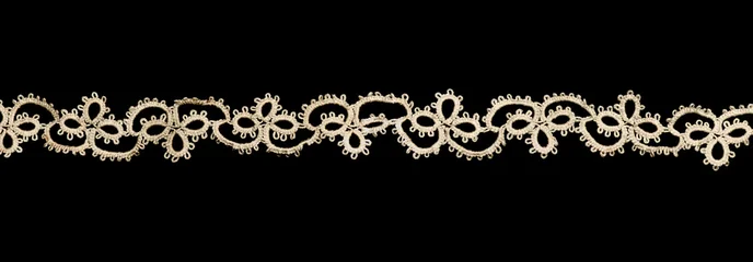 Tatting lace frivolite tape isolated on black background, top view,  handmade. gimp trim, vintage textile design, antique fabric art, needlework © Subbotina Anna