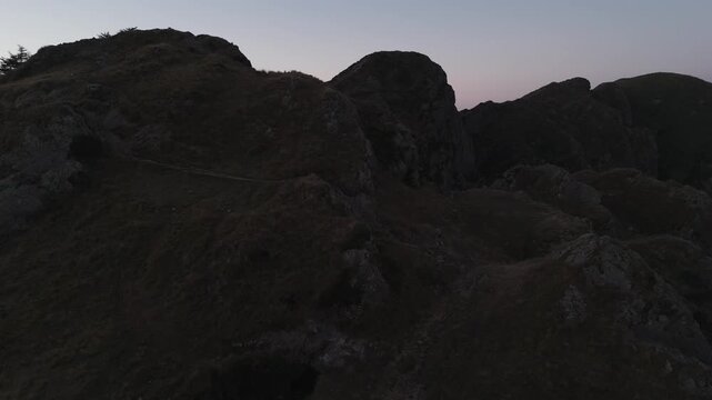 Man hiking and running on the top of the mountains at sunset time, at the Basque Country.