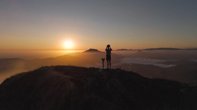 Man hiking and running on the top of the mountains at sunset time, at the Basque Country.