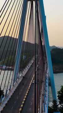 Aerial View of Cable Stayed Barelang Bridge with Vehicle Traffic Crossing Sea Strait at Sunset