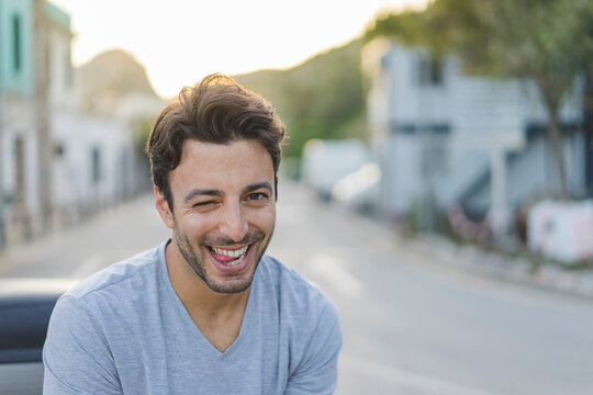 Portrait of laughing young man pulling funny faces