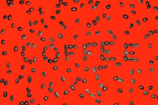 Coffee beans spelling the word coffee on a red background