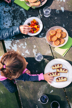Top view of little girl and woman having picnic