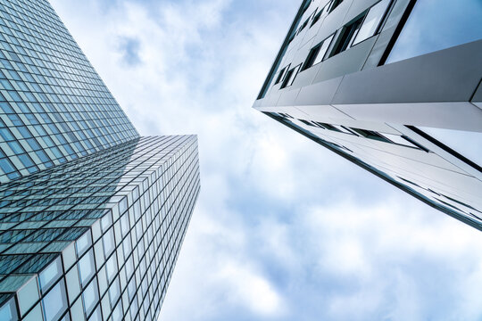 Modern glass skyscrapers reflect the cloudy sky in Hamburg
