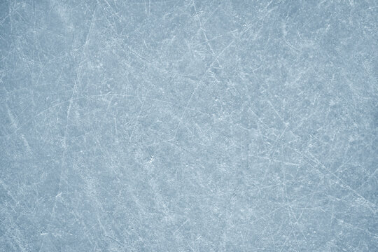 An ice surface as an ice rink with ice skates tracks. Winter sports texture. Poster with copy space.