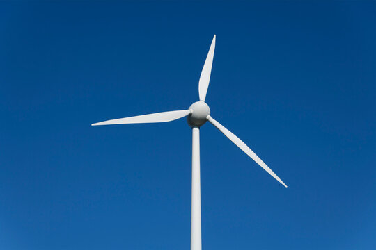 Germany, Bavaria, Wind turbine against blue sky