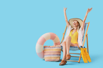 Summer vacation and travel freedom, happy woman relaxing in beach chair with arms raised for holiday leisure and tropical resort lifestyle enjoyment © Pixel-Shot
