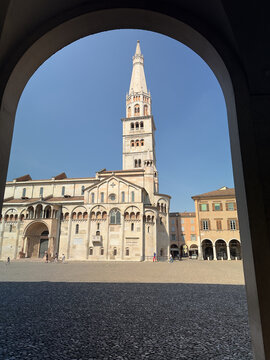 Modena Cathedral and Ghirlandina tower viewed from Piazza Grande on a bright sunny summer day, Emilia-Romagna, Italy.
