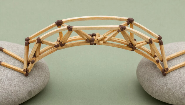 Matchstick bridge connecting two stones symbolizing connection teamwork and problem solving concept