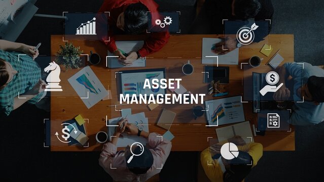 A diverse team collaborates in a modern workspace, focusing on asset management strategies while using charts and tools for effective financial analysis and planning. Raster