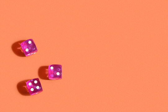 Purple game dices on orange background