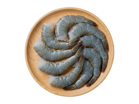 Raw fresh prawns arranged in a spiral pattern on a wooden plate with raw shrimp white background ready to cook