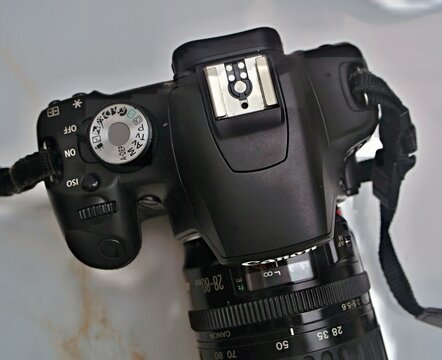 Canon DSLR camera body and lens on white