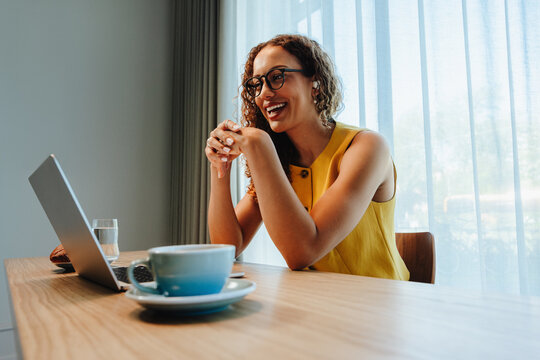 Woman smiles during video call for remote work at office