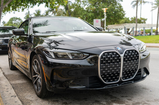 Miami, Florida, USA - May 05, 2025: Luxury convertible car BMW 4. Car BMW 4 convertible parked outdoor. Black convertible car, corner view. BMW 4 Series convertible 2020 car