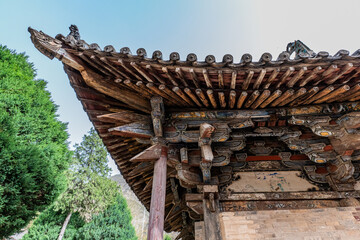 Ornate Wooden Eaves of Longmen Temple in Pingshun County, Shanxi, China © TranPhuoc