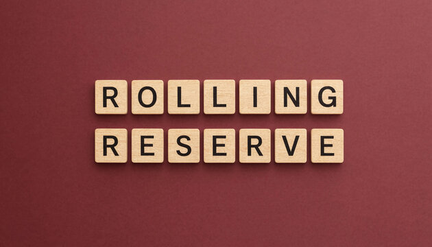 Rolling reserve concept spelled with wooden letter tiles on maroon background for business finance strategy