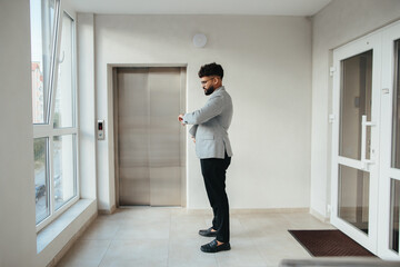 Professional man checking watch waiting for elevator © dsheremeta