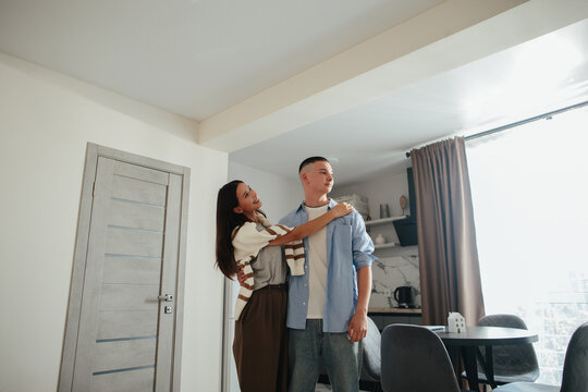 Young couple contemplating new home moving together