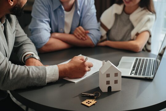 Agent discussing real estate contract with couple