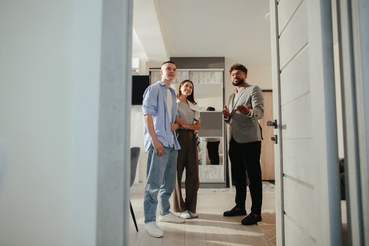 Real estate agent showing modern apartment to clients