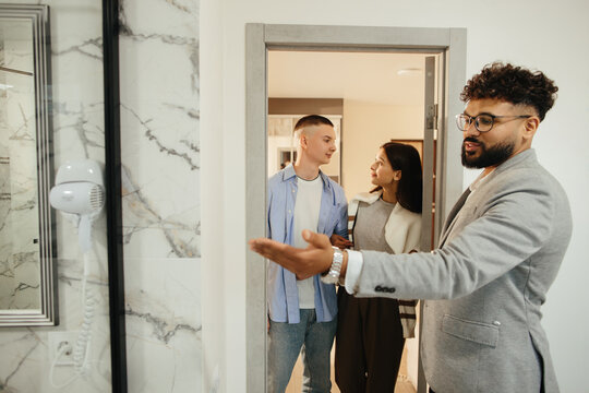 Real estate agent showing apartment to young couple