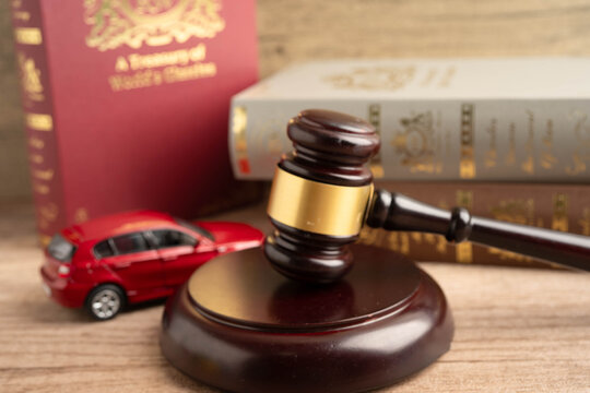 Bangkok, Thailand March 15, 2023 Car accident lawsuit and insurance, Judge hammer with car model.