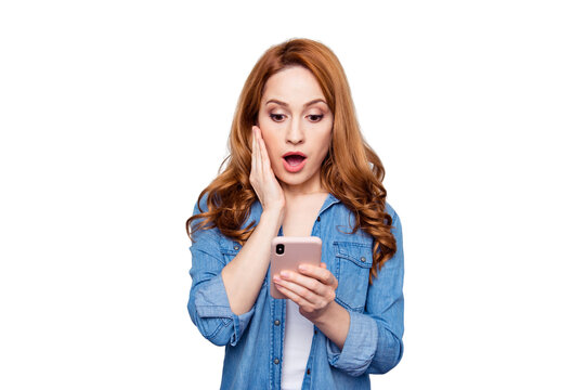 Close up photo beautiful she her curly foxy lady arm hand telephone reader news check instagram followers pictures unexpected unbelievable wear casual blue jeans denim shirt isolated grey background
