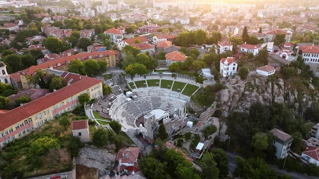 Aerial drone view of ancient Roman amphitheater and Plovdiv old town at morning sunrise in Bulgaria