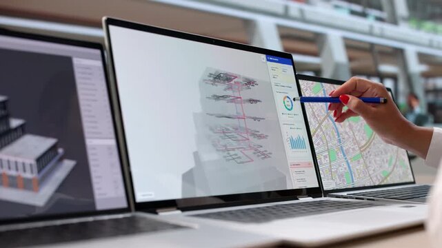 Architect Carefully Reviews 3D Design On Laptop