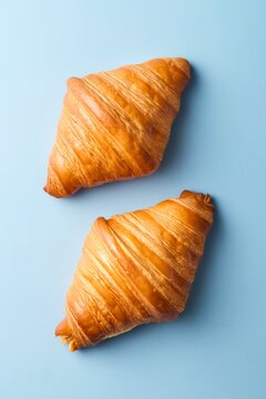 Croissants on blue background. Top view