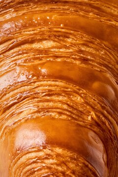 Flaky crispy croissant close up with great texture. All in focus, full frame