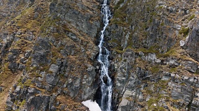 Aerial view Seven Rila Lakes deep blue glacial lake rocky cirque snow fields Rila national park mountain peak Bulgaria travel trekking outdoor adventure nature background drone footage