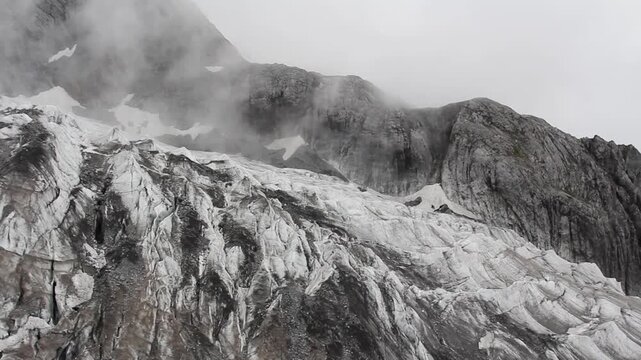 Melting glacier on rocky mountain in China due to global warming